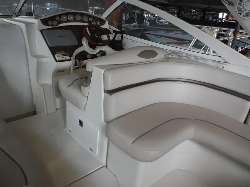 Slide: The Image of Interior of 2002 Doral 310se boat with white seating and control panel. - 33