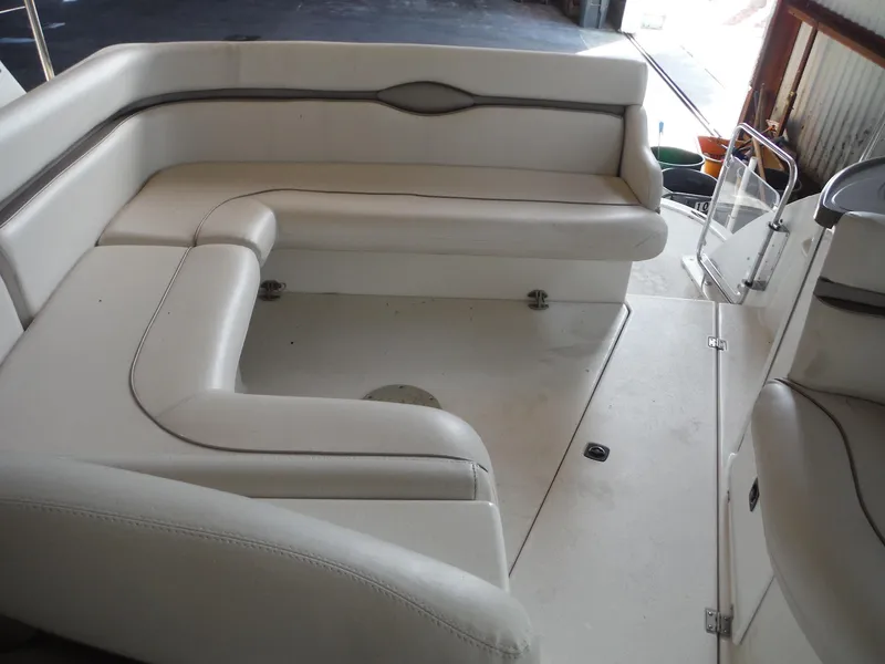 Slide: The Image of 2002 Doral 310se boat interior with white seating and spacious layout. - 34