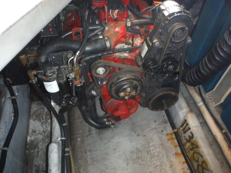 Slide: The Image of Engine compartment of a 2002 Doral 310se boat, featuring mechanical components and hoses. - 35