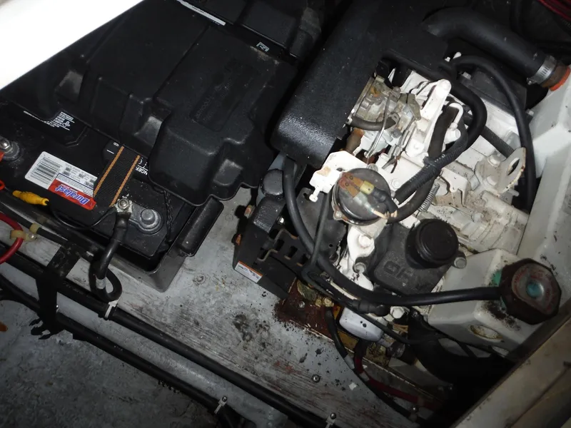 Slide: The Image of Engine compartment of a 2002 Doral 310se boat, showing battery and engine components. - 36