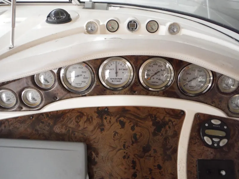 Slide: The Image of Dashboard of a 2002 Doral 310se boat with multiple gauges and controls. - 40