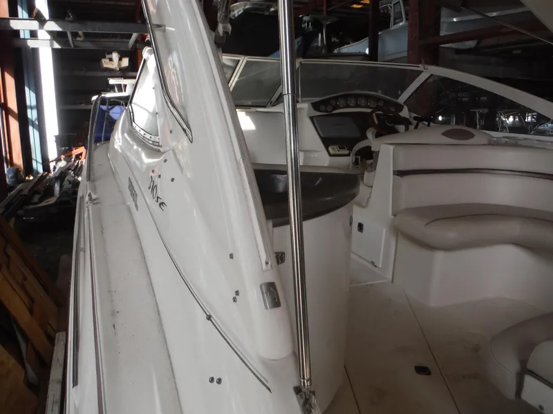 Slide: The Image of 2002 Doral 310se boat interior with seating and dashboard in storage. - 41
