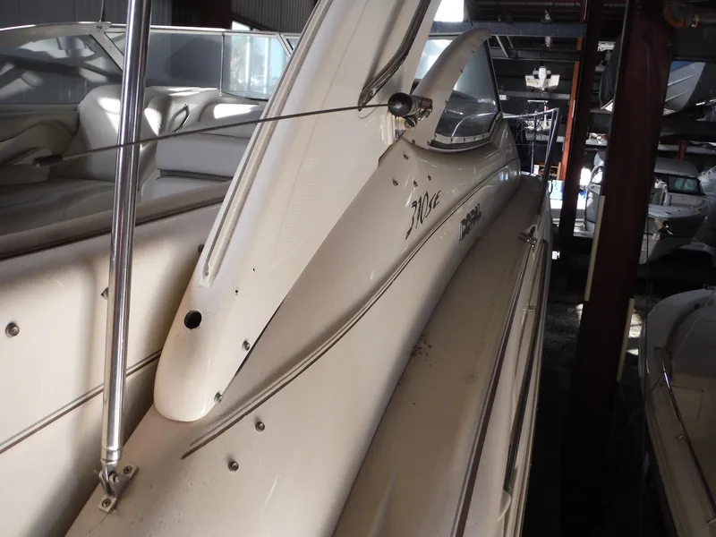 Slide: The Image of 2002 Doral 310se boat in storage, side view with sleek design. - 42