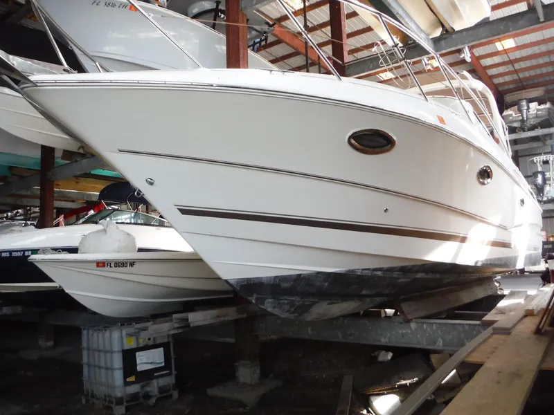 Slide: The Image of 2002 Doral 310se boat in indoor storage, side view. - 43