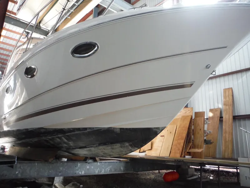 Slide: The Image of 2002 Doral 310se boat in storage, side view with sleek design. - 44