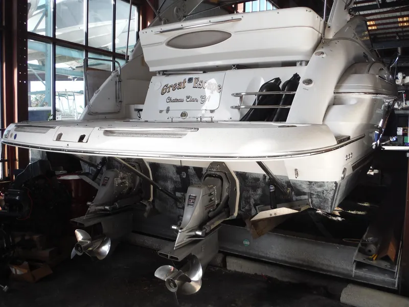 Slide: The Image of 2002 Doral 310se boat in a marina, showcasing dual propellers and sleek design. - 46