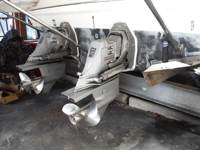 Slide: The Image of 2002 Doral 310se boat with dual propeller outdrives in a garage. - 47