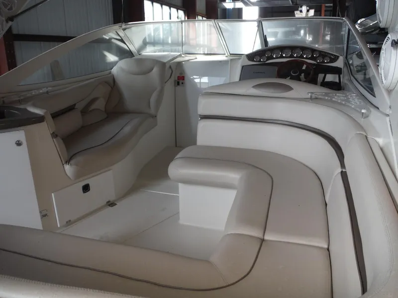 Slide: The Image of 2002 Doral 310se boat interior with white leather seating and dashboard. - 9