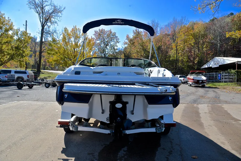 Slide: The Image of 2018 Monterey 204 FS boat parked on a sunny day with autumn trees. - 13