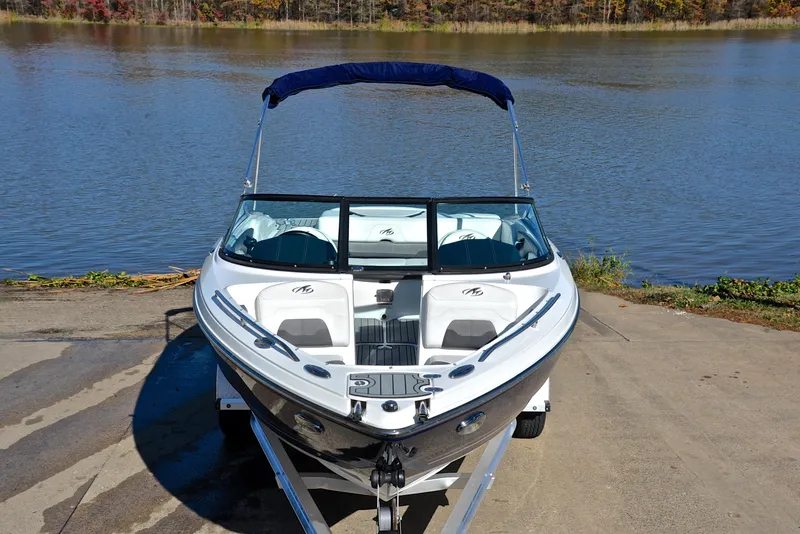 Slide: The Image of 2018 Monterey 204 FS boat on trailer by a lake. - 17