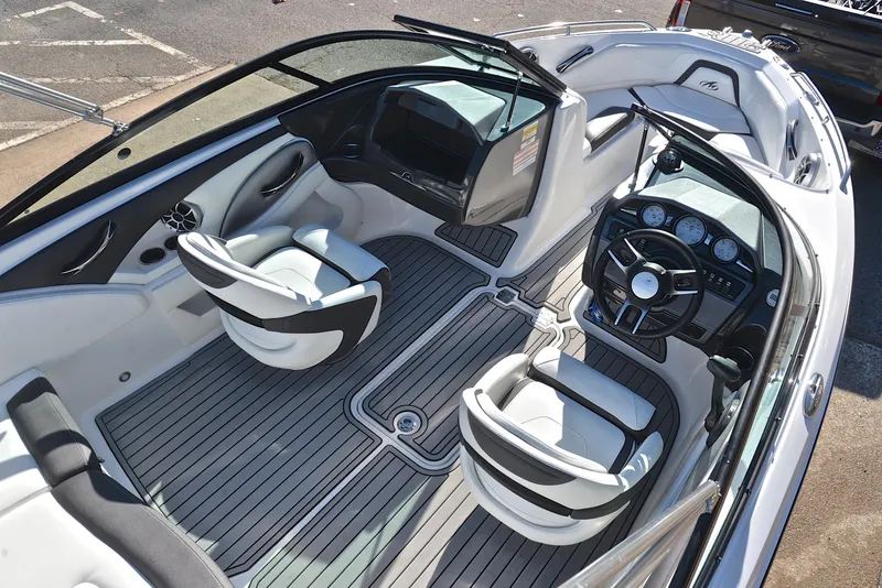 Slide: The Image of 2018 Monterey 204 FS boat interior with sleek seating and modern dashboard. - 19