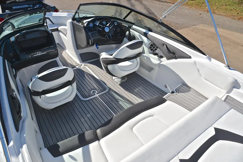 Slide: The Image of 2018 Monterey 204 FS boat interior with sleek seating and modern dashboard. - 23