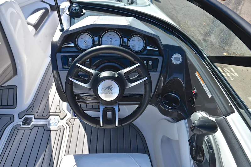 Slide: The Image of 2018 Monterey 204 FS boat dashboard with steering wheel and gauges. - 25