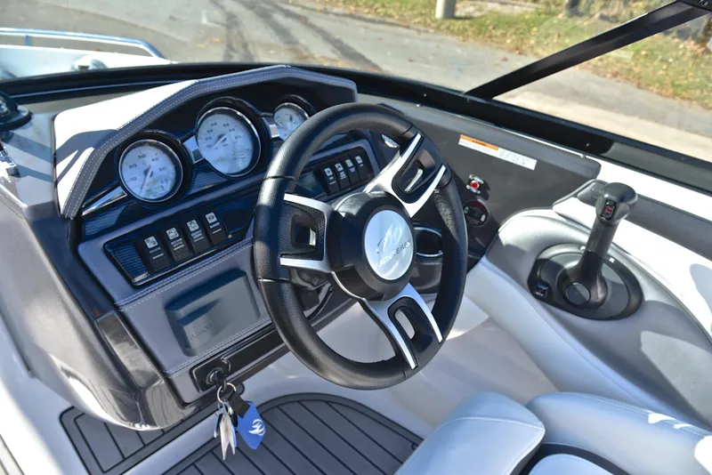 Slide: The Image of 2018 Monterey 204 FS boat dashboard with steering wheel and control panel. - 26