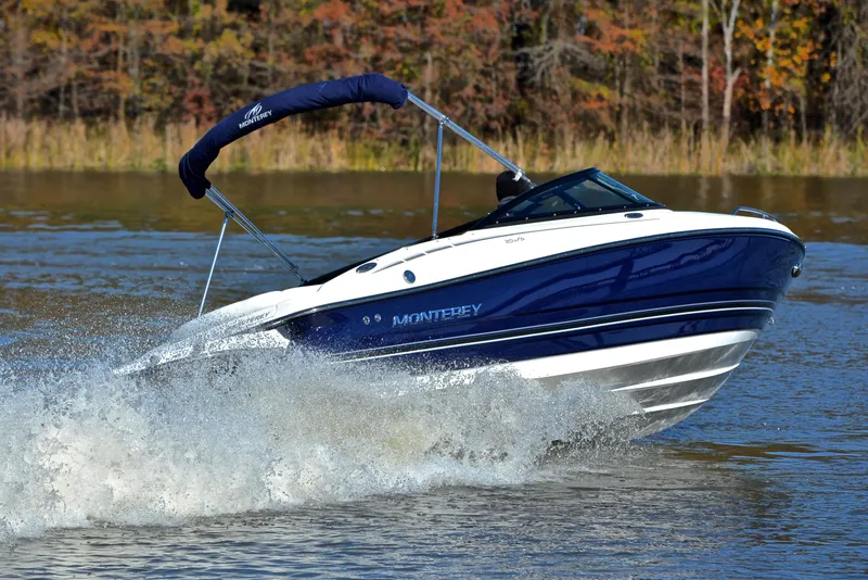 Slide: The Image of 2018 Monterey 204 FS speedboat cruising on a lake with autumn foliage. - 5