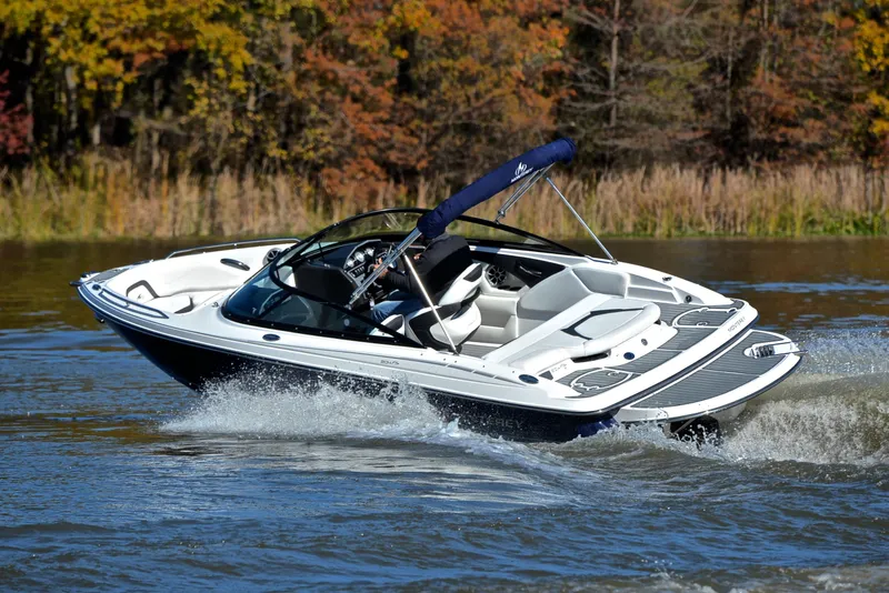 Slide: The Image of 2018 Monterey 204 FS boat cruising on a lake with autumn foliage. - 6