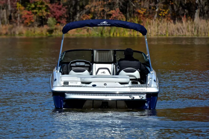 Slide: The Image of 2018 Monterey 204 FS boat cruising on a calm lake with autumn foliage. - 8