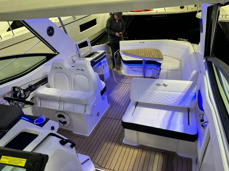 Slide: The Image of 2019 Sea Ray Sundancer 320 interior with luxurious white seating and modern design. - 11