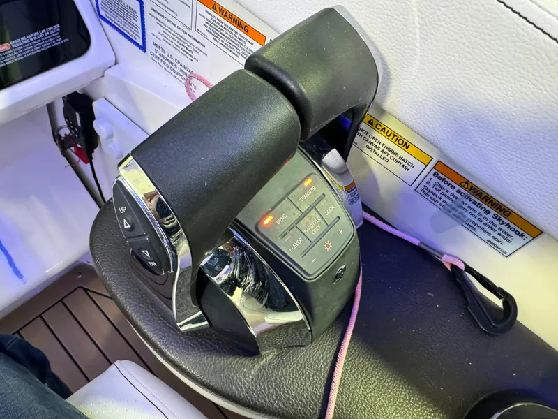 Slide: The Image of 2019 Sea Ray Sundancer 320 helm with modern controls and navigation displays. - 13