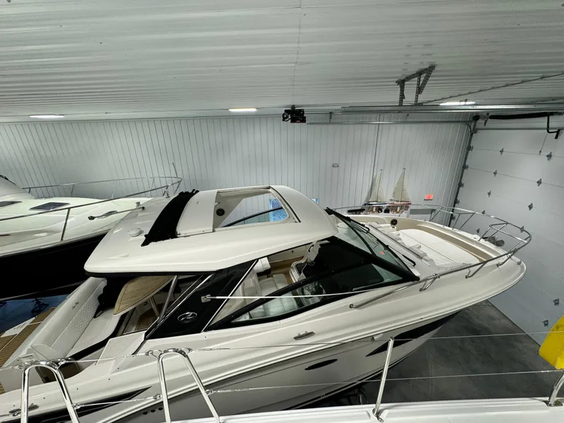 Slide: The Image of 2019 Sea Ray Sundancer 320 yacht in a showroom, showcasing sleek design and luxury features. - 5
