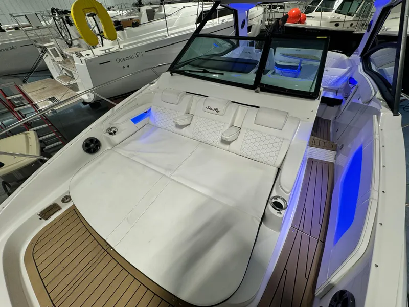Slide: The Image of 2019 Sea Ray Sundancer 320 boats in a spacious indoor storage facility. - 7