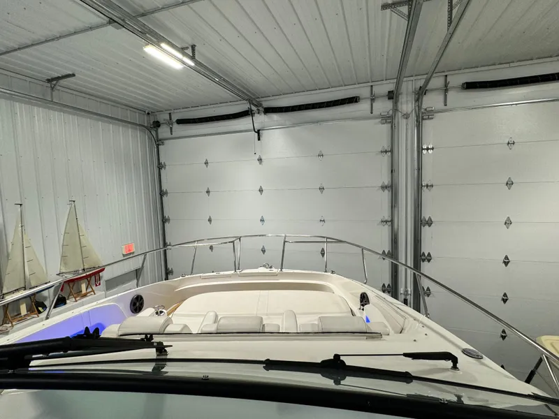 Slide: The Image of 2019 Sea Ray Sundancer 320 yacht interior with luxurious seating in a showroom. - 8