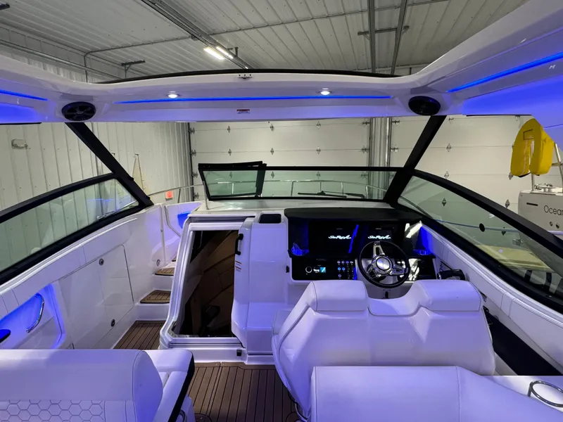 Slide: The Image of 2019 Sea Ray Sundancer 320 interior with embroidered logo on white seating. - 9