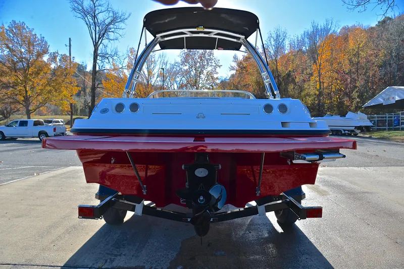 Slide: The Image of 2015 Bayliner 195 boat, red and white, parked on a sunny autumn day. - 13
