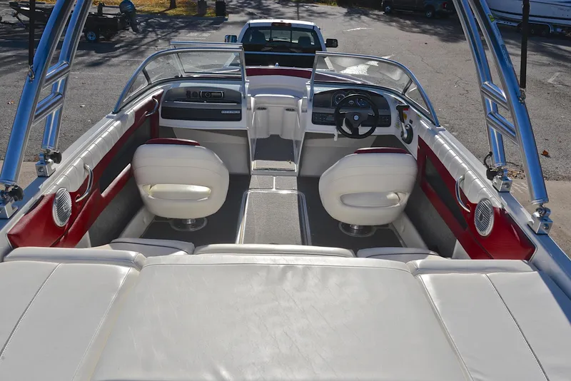 Slide: The Image of 2015 Bayliner 195 boat interior with white seating and red accents. - 18