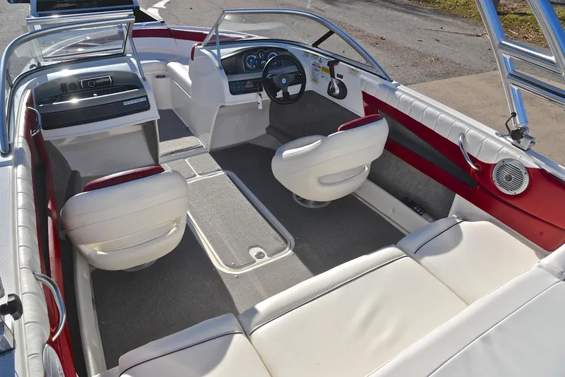 Slide: The Image of 2015 Bayliner 195 boat interior with white seating and modern dashboard. - 23