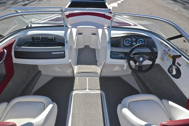 Slide: The Image of 2015 Bayliner 195 boat interior with steering wheel and seating. - 24