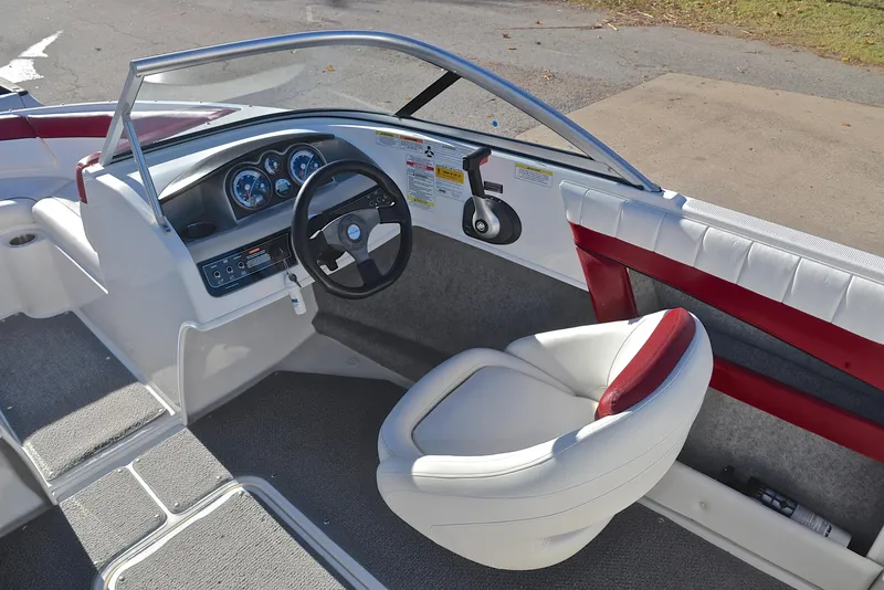Slide: The Image of 2015 Bayliner 195 boat interior with steering wheel and seating. - 25