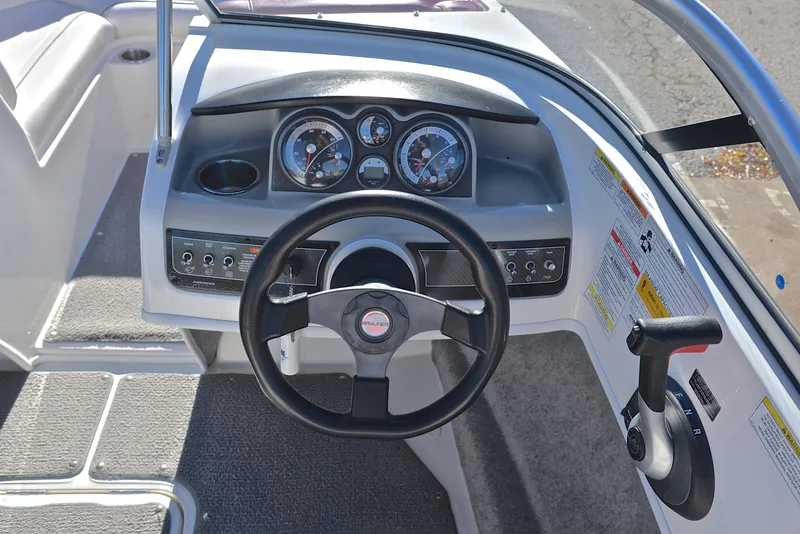 Slide: The Image of 2015 Bayliner 195 boat dashboard with steering wheel and control panel. - 26