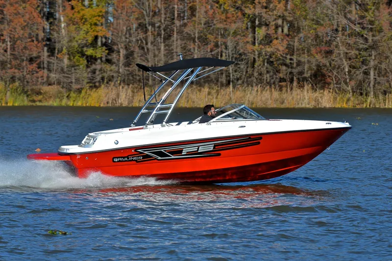 Slide: The Image of 2015 Bayliner 195 boat cruising on a lake with autumn trees in the background. - 3