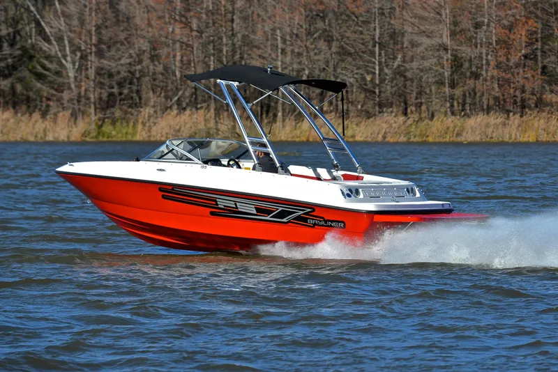 Slide: The Image of 2015 Bayliner 195 boat cruising on a lake with a black canopy. - 4