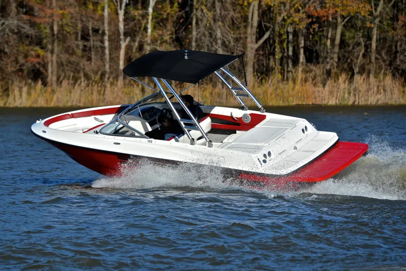 Slide: The Image of 2015 Bayliner 195 boat cruising on a lake with a red and white design. - 6