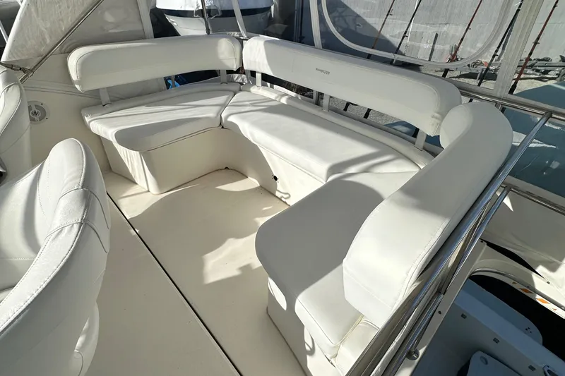 Slide: The Image of 2005 Silverton 34 Convertible yacht with white leather seating in the cockpit area. - 11