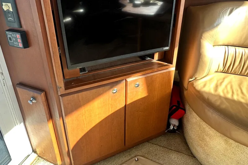 Slide: The Image of Interior of 2005 Silverton 34 Convertible with TV and wooden cabinet. - 13