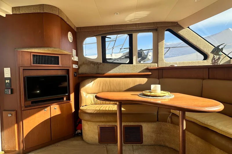 Slide: The Image of Interior of 2005 Silverton 34 Convertible yacht with cozy seating and TV. - 14