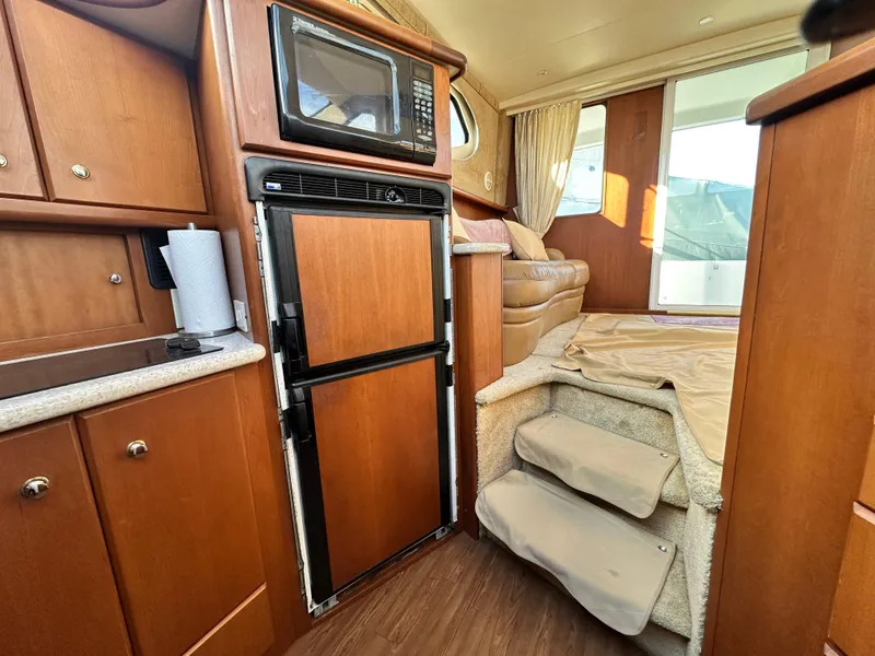 Slide: The Image of Interior of 2005 Silverton 34 Convertible yacht with kitchen and stairs. - 15