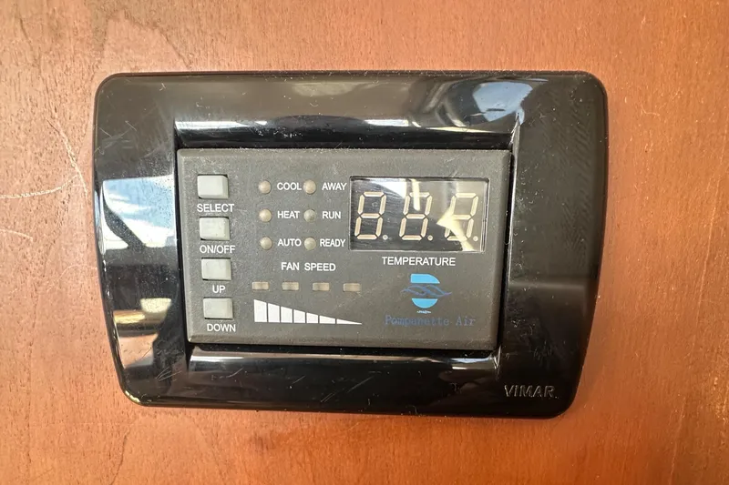 Slide: The Image of Thermostat control panel on 2005 Silverton 34 Convertible boat, displaying temperature settings. - 17