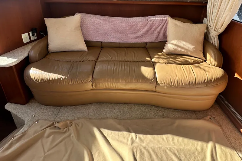 Slide: The Image of 2005 Silverton 34 Convertible interior with tan leather sofa and cushions. - 18