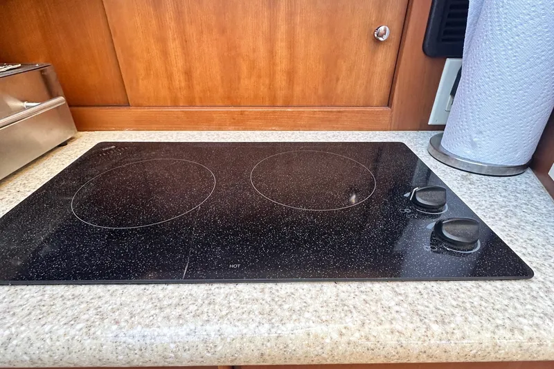 Slide: The Image of Stovetop in 2005 Silverton 34 Convertible yacht kitchen, featuring two burners and sleek design. - 19