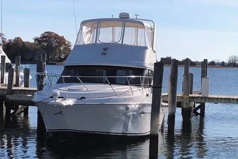 Slide: The Image of 2005 Silverton 34 Convertible yacht docked at a marina. - 2