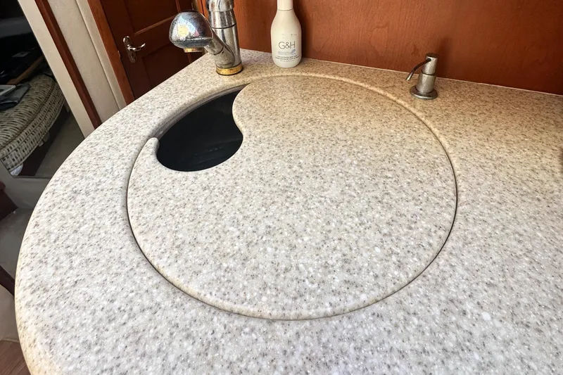 Slide: The Image of 2005 Silverton 34 Convertible yacht kitchen sink with round cover and faucet. - 20