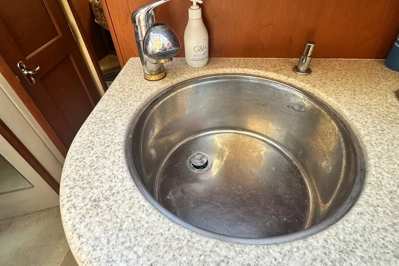 Slide: The Image of Stainless steel sink in 2005 Silverton 34 Convertible boat bathroom. - 21