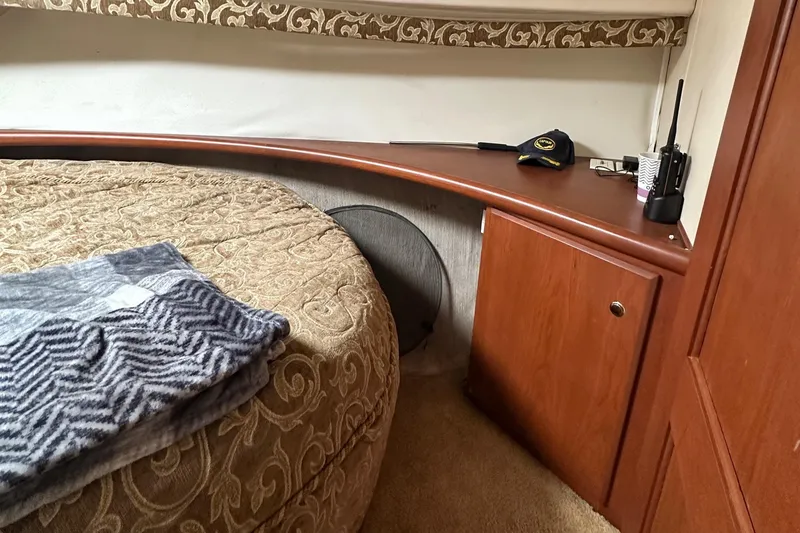 Slide: The Image of Cozy interior of 2005 Silverton 34 Convertible yacht with bed and wooden cabinetry. - 23