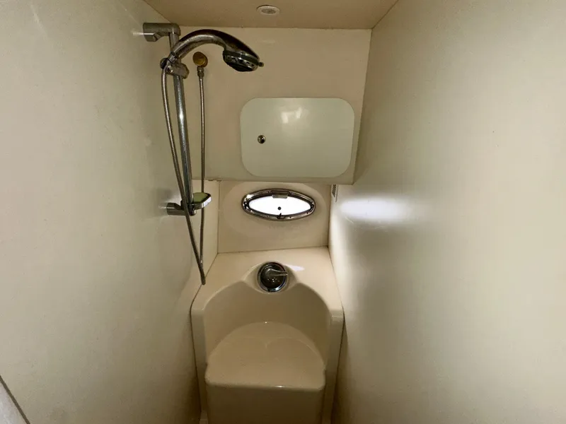 Slide: The Image of 2005 Silverton 34 Convertible yacht bathroom with shower and porthole window. - 25