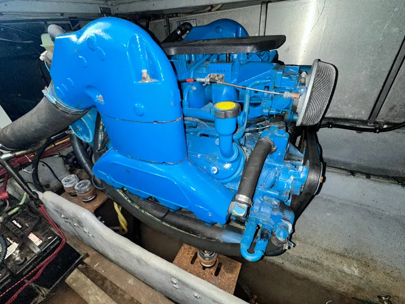 Slide: The Image of Engine of a 2005 Silverton 34 Convertible boat, painted blue, in a clean compartment. - 29