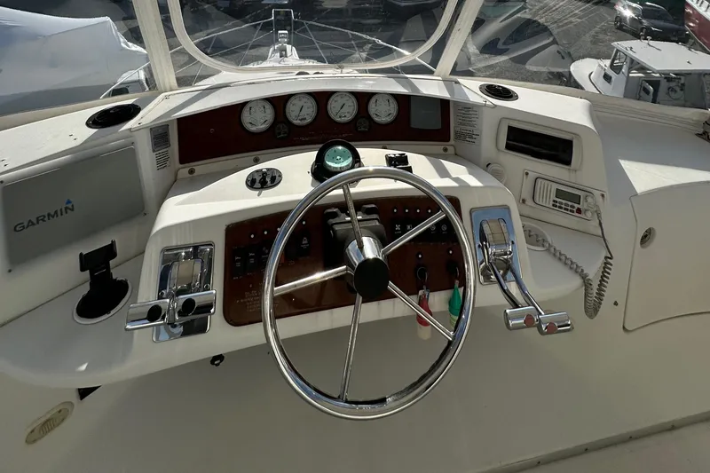 Slide: The Image of 2005 Silverton 34 Convertible boat helm with steering wheel and navigation instruments. - 3